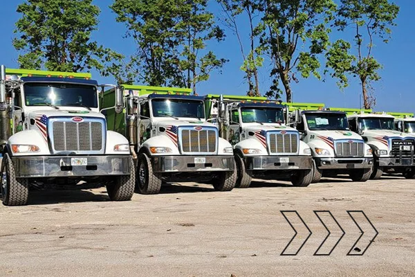 Picture of six dump trucks lined up in a row